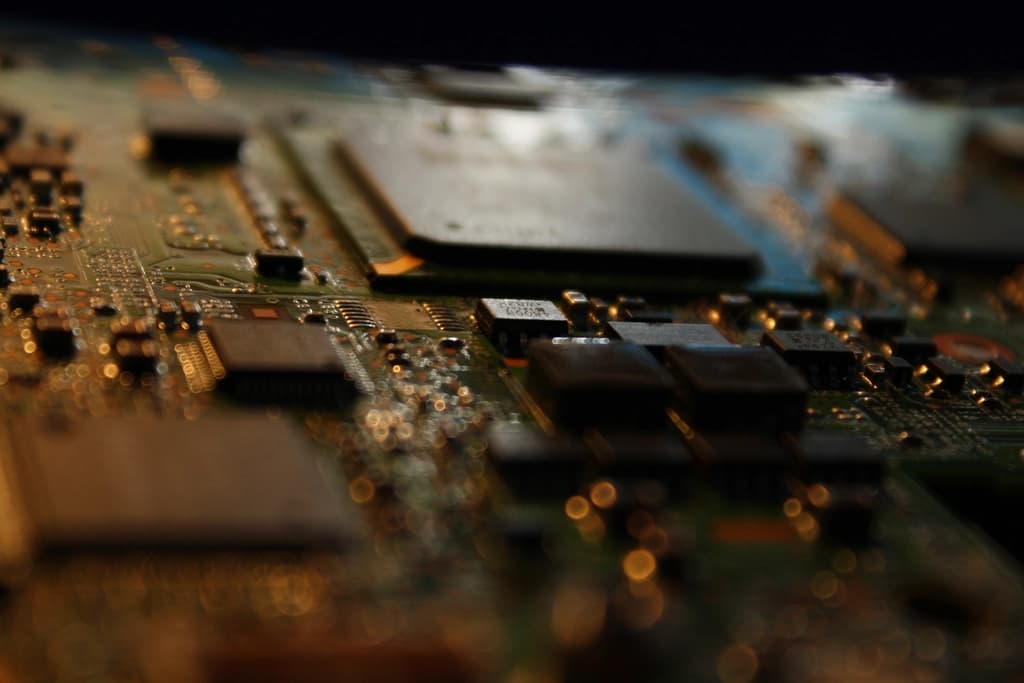 A close-up of a computer chip and motherboard representing the computing infrastructure behind AI