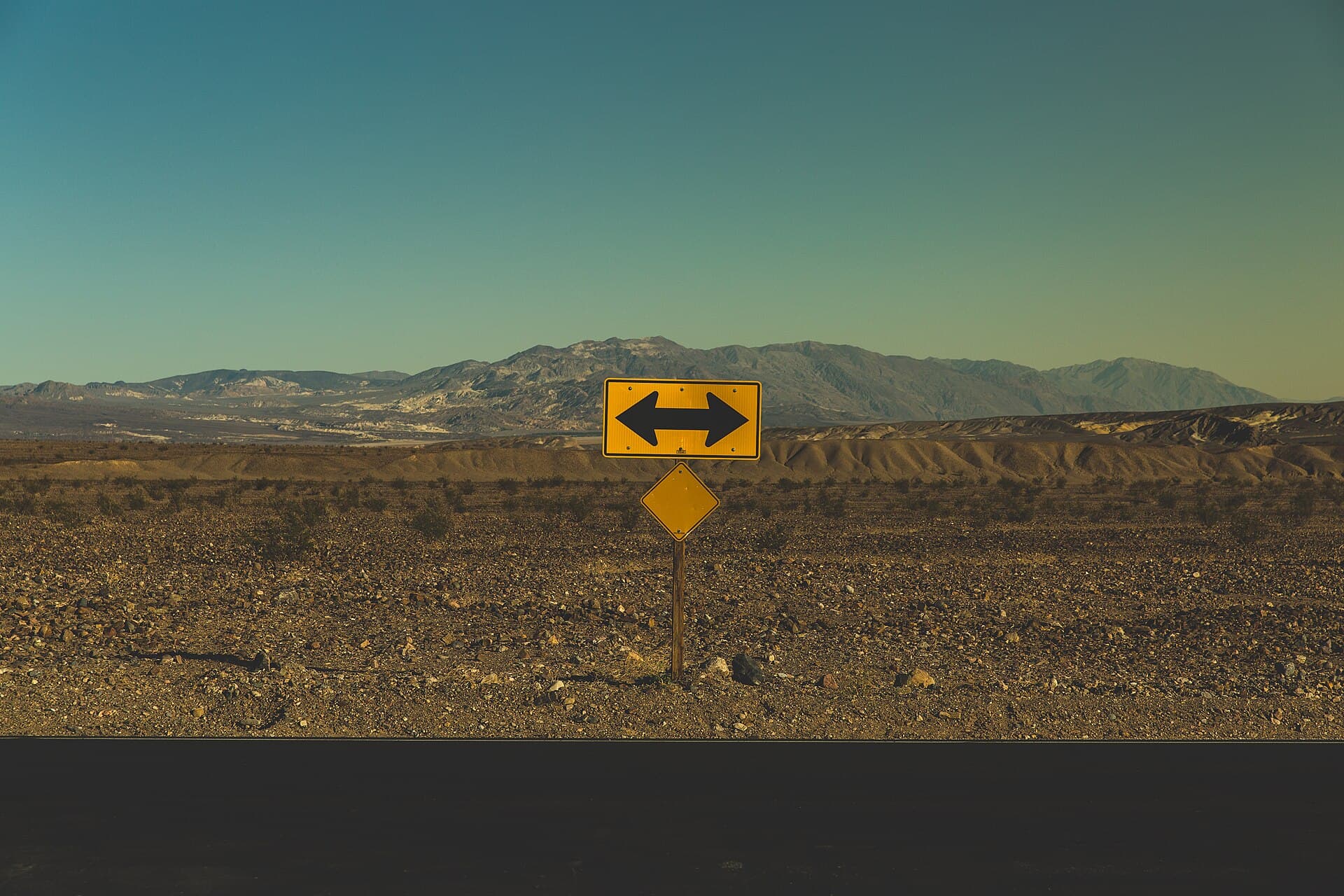 A road sign pointing in two opposing directions