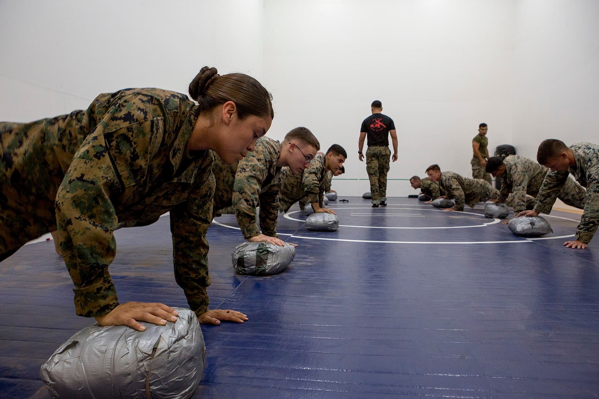 An instructor guiding a student through a hands-on training exercise